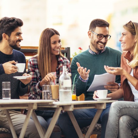 Four Friends Having a Conversation while Having Coffee Drinks